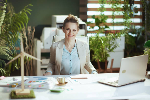 A business professional in a modern office works on a laptop, learning how to accept online payments in the UAE.